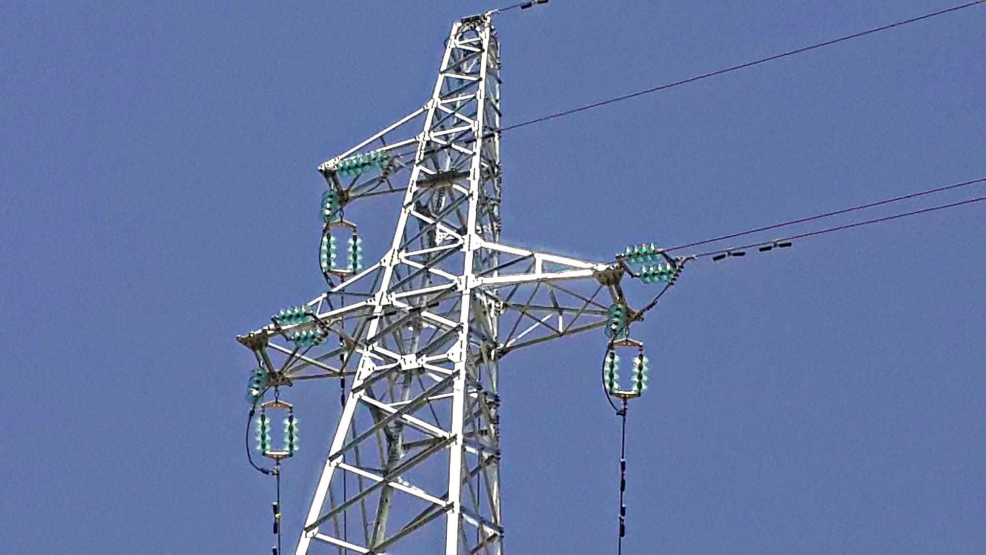Détail d'un pylône haute tension : consoles et chaînes d'isolateurs en verre de la ligne interconnectée